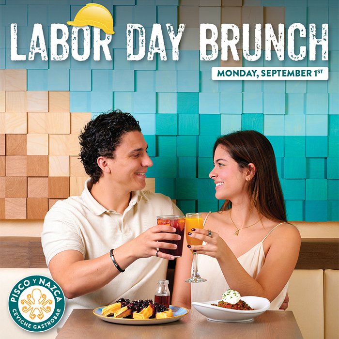 “Couple toasting mimosas and sangría beside waffles topped with blueberry compote as syrup is poured.