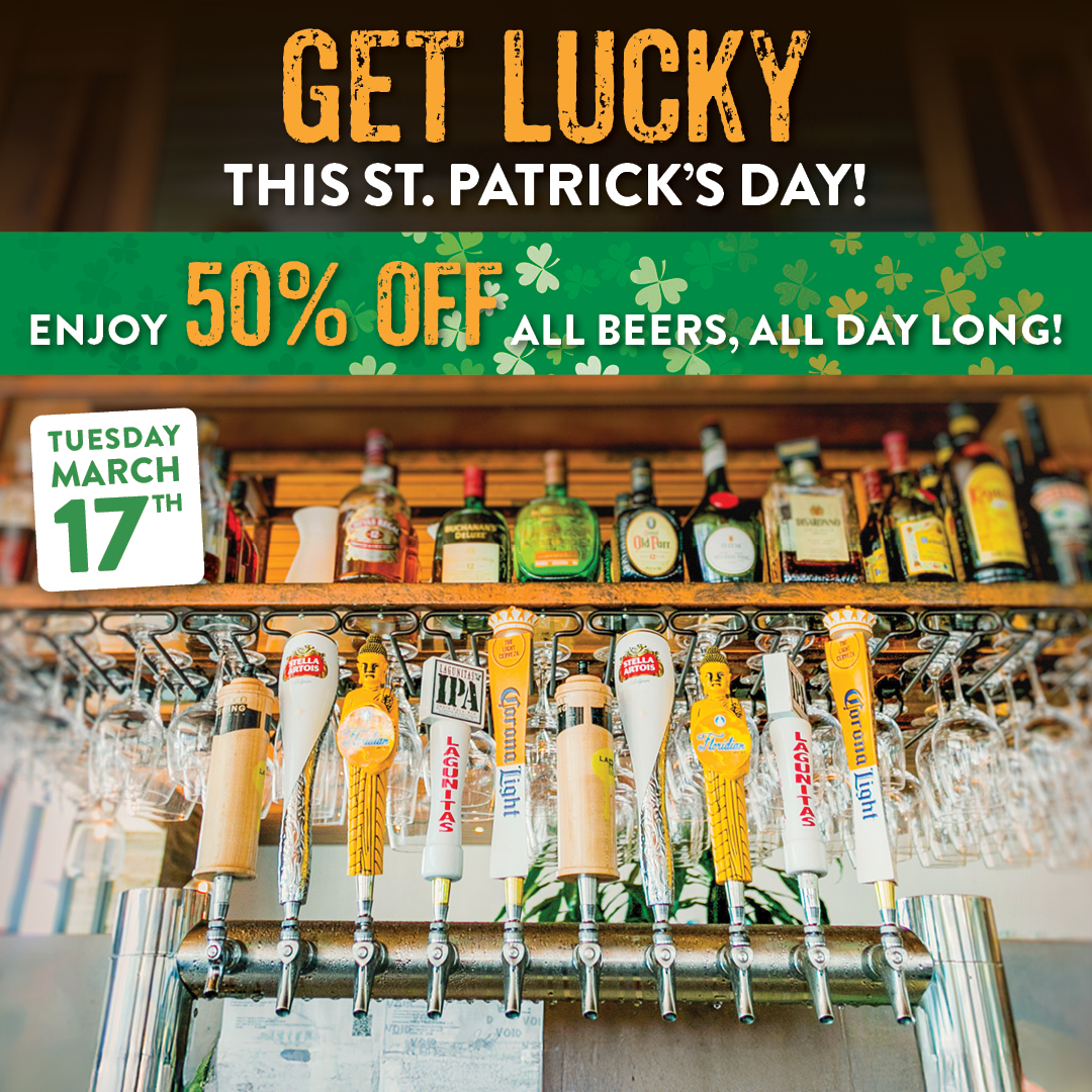 Beer taps and bottles behind a bar promoting St. Patrick’s Day with text “Get Lucky This St. Patrick’s Day” and “Enjoy 50% Off All Beers, All Day Long” on Tuesday, March 17.